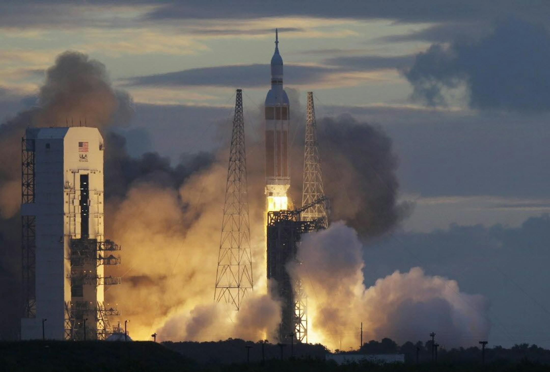 A NASA Orion capsule on top of a Delta IV rocket lifts off on its first unmanned orbital test flight from Cape Canaveral Air Force Station, Friday, Dec. 5, 2014 at Cape Canaveral, Fla.