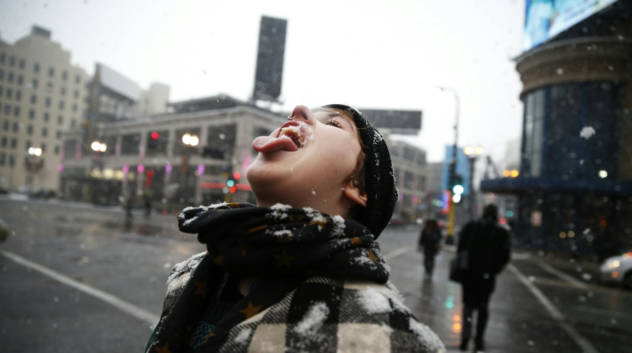 In downtown Minneapolis, as big wet flakes of snow came down, Rachel Auna enjoyed the weather as she was canvassing for a nonprofit downtown.]richard tsong-taatarii/rtsong-taatarii@startribune.com