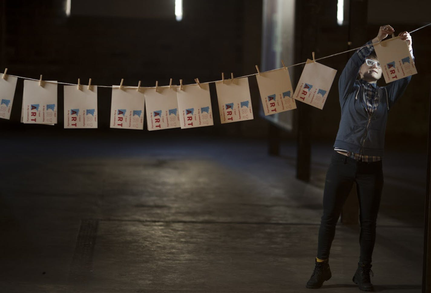 Artist Camille Erickson pinned screen-printed postcards on a line at the Soap Factory in 2017 as part of a project to support the National Endowment for the Arts.