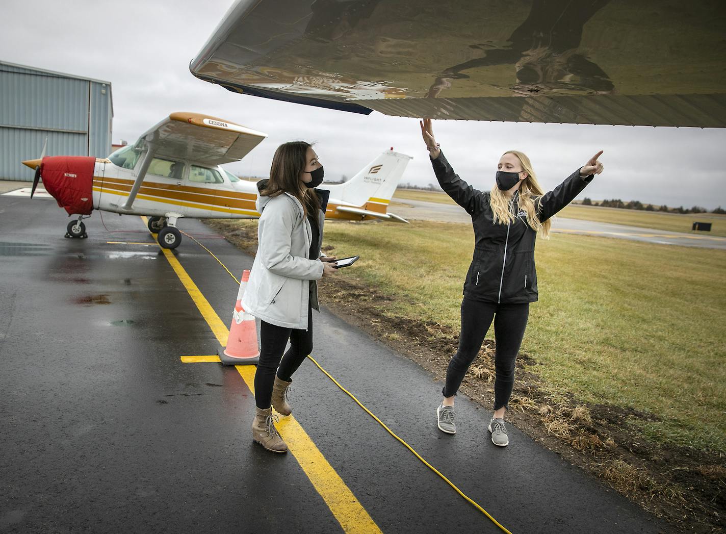 Sara Weidler, right, an instructor for InFlight Pilot Training, worked with student pilot Shea Kieren at Flying Cloud Airport. Regional airfields are seeing a big jump in interest as people have more time to focus on their goals.