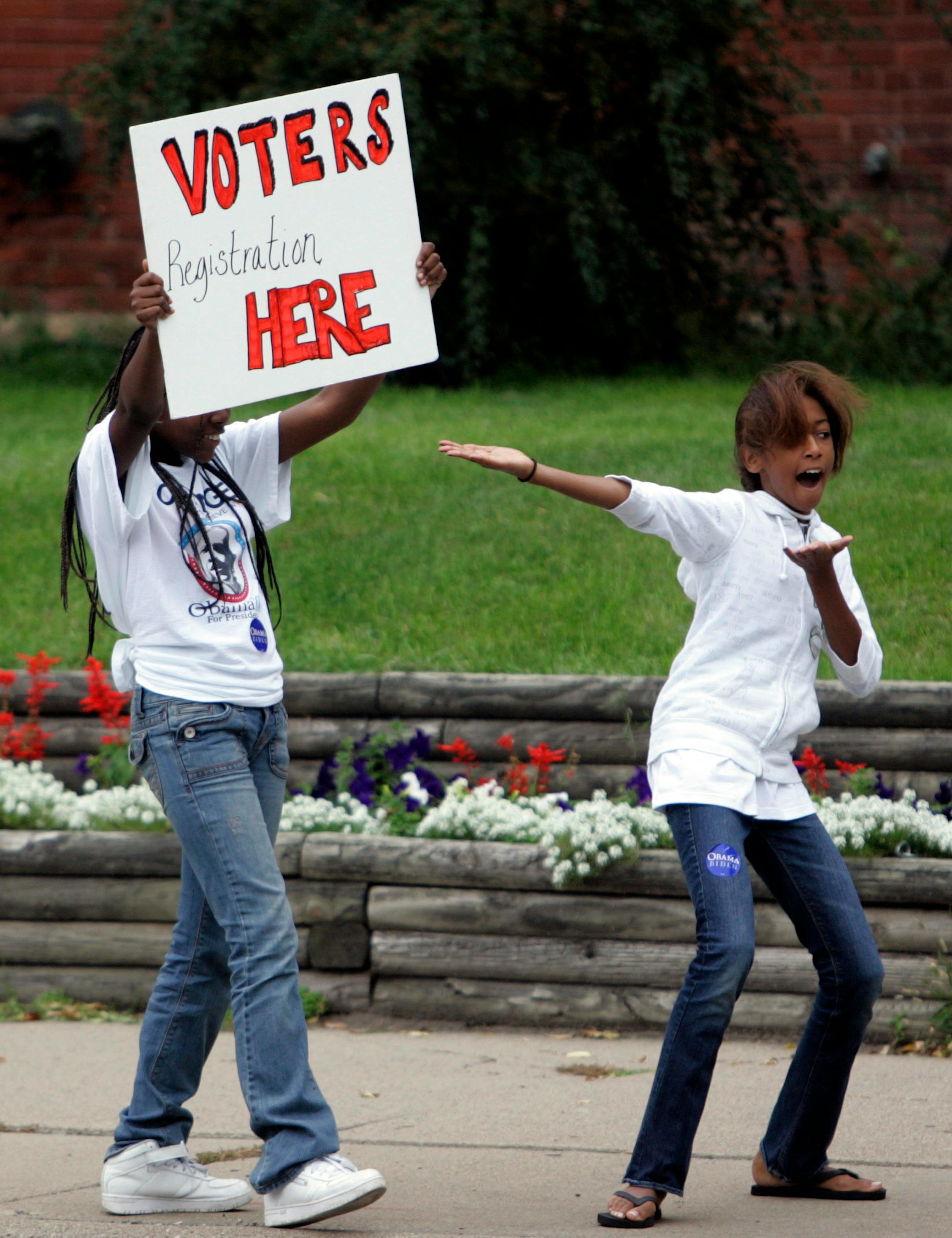Monica Hyacinthe, left, and Tamara Wright tried to get drivers to stop and register to vote in North Minneapolis.