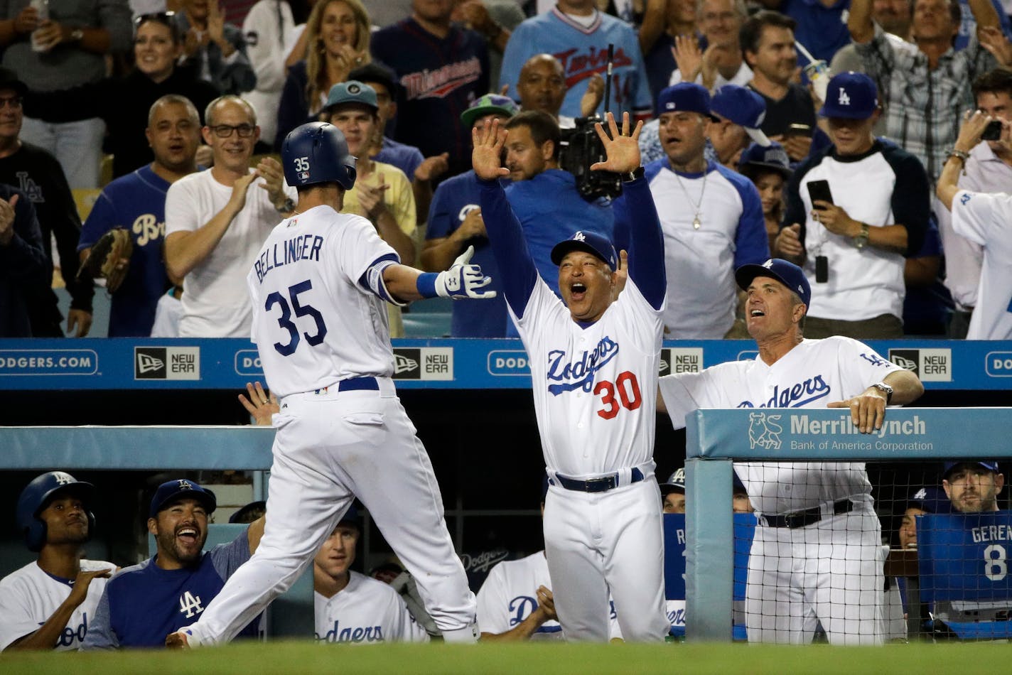 Los Angeles Dodgers' Cody Bellinger, left, is greeted by manager Dave Roberts after hitting three-run home run during the eighth inning of a baseball game against the Minnesota Twins, Monday, July 24, 2017, in Los Angeles. (AP Photo/Jae C. Hong)