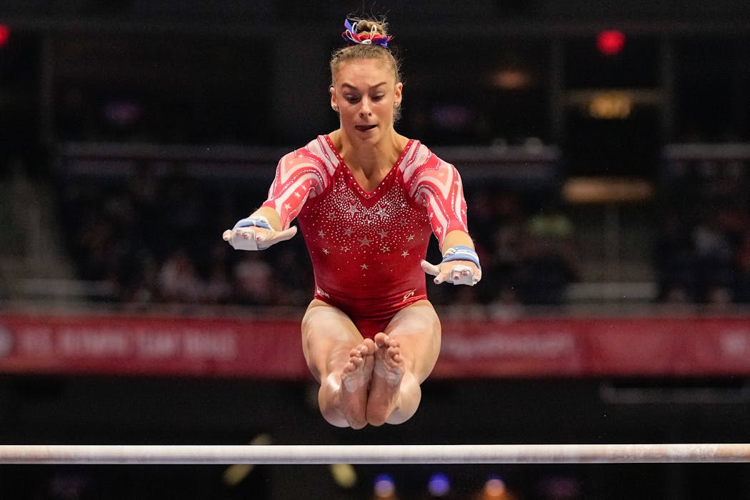 Grace McCallum competed on the uneven bars Sunday. She moved up to fourth place in the all-around by improving her first-day marks on vault and bars, helping her earn an Olympic berth.