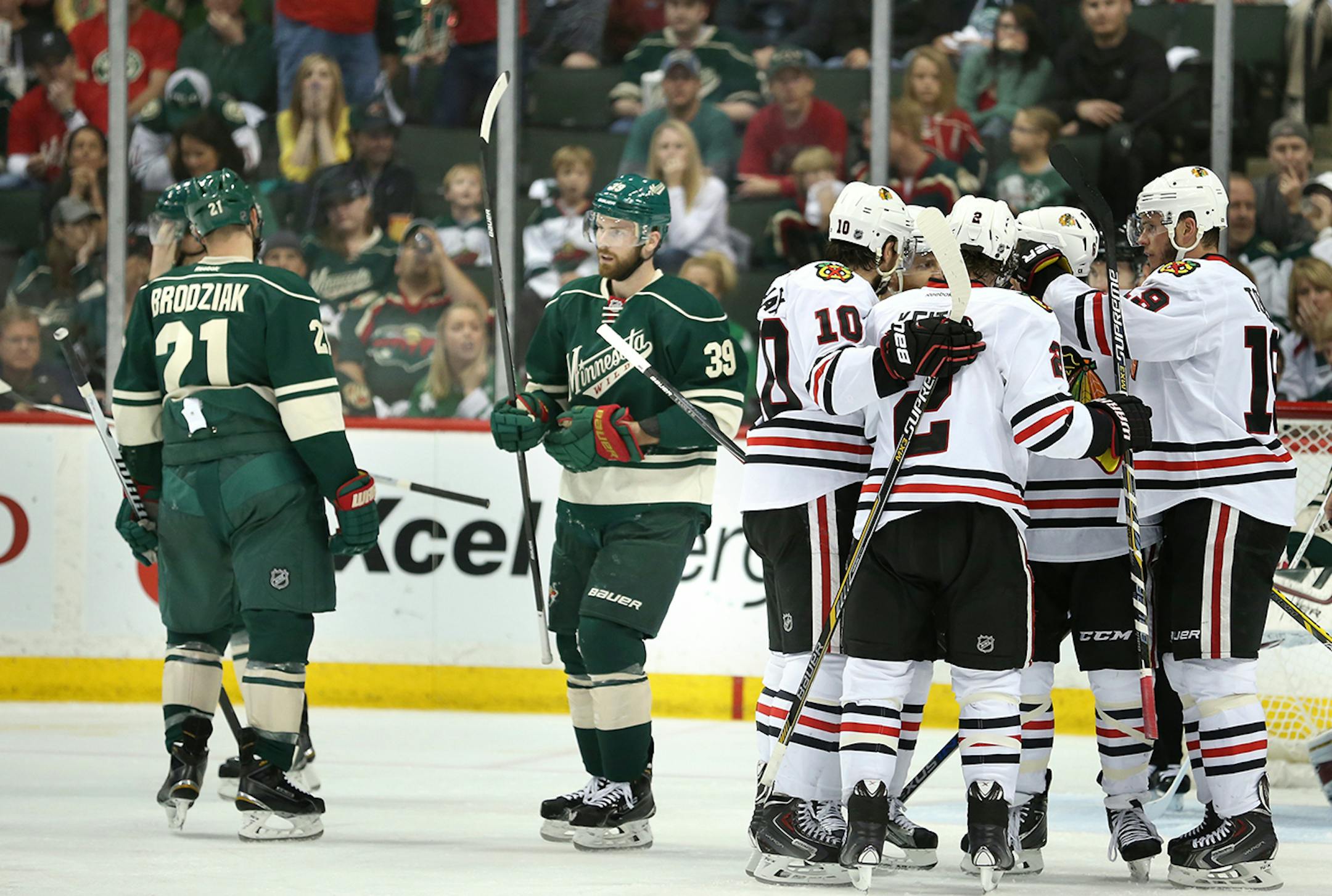 The Chicago Blackhawks celebrated a goal by Chicago Blackhawks center Andrew Shaw (65) during the second period as Minnesota Wild center Kyle Brodziak (21) and defenseman Nate Prosser (39) look on Thursday night.
