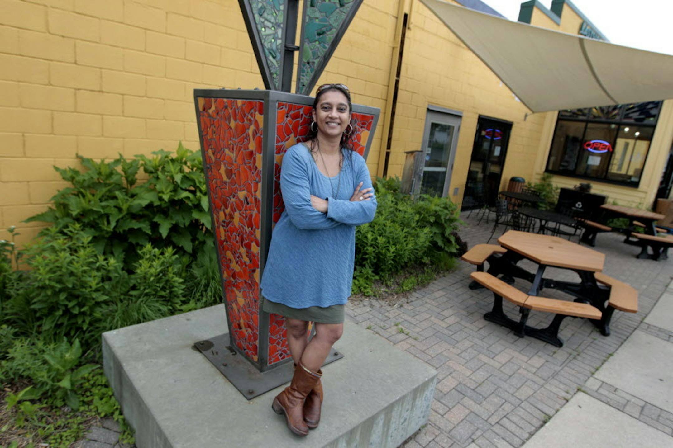 June 9, 2014: Eastside Food Coop President Manisha Nordine, leaned on their new "carrot" logo at the coop in Minneapolis, MN.