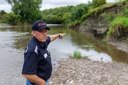 Zumbro Falls Mayor Bruce Heitmann pointed out the erosion on a dike that protects his city of 207 residents from the Zumbro River. The city is seeking