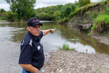 Zumbro Falls Mayor Bruce Heitmann pointed out the erosion on a dike that protects his city of 207 residents from the Zumbro River. The city is seeking