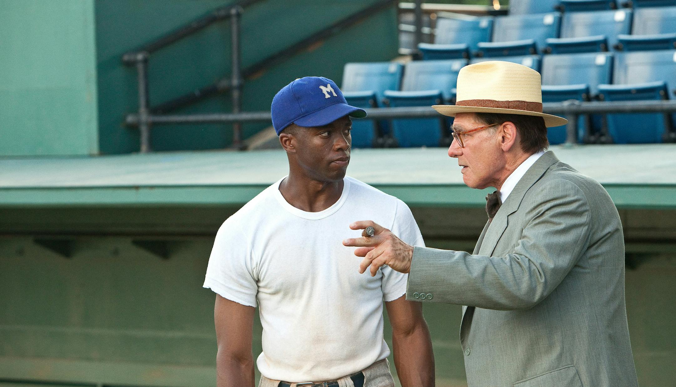 (L-r) CHADWICK BOSEMAN as Jackie Robinson and HARRISON FORD as Branch Rickey in Warner Bros. Pictures‚Äô and Legendary Pictures‚Äô drama ‚Äú42,‚Äù a Warner Bros. Pictures release.