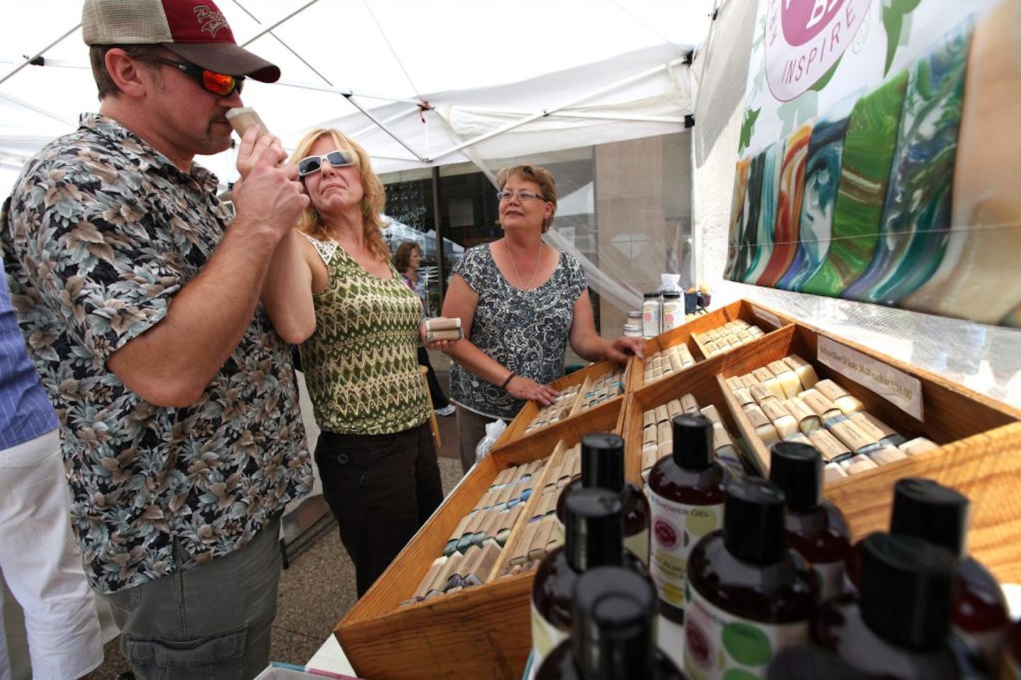 Amy Brooks right helped customers Karl Seewald left and and his girlfriend Michelle Drivdahl at her hand-crafted soaps shop Thursday June 28, 2012 in Rochester, MN. Rooks of Rochester , sells soaps that are designed to reduced skin irritation to cancer patients as they go through therapy.