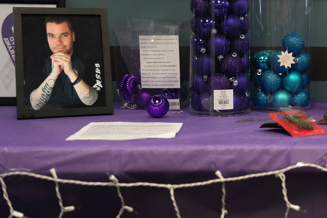 A photo of Ryan Anderson, who died of an overdose in 2017, sits on table with supplies for people to make Christmas ornaments at the Valhalla Place treatment center in Brooklyn Park in 2022. Anderson's fiancé, Anne Emerson, started the project to craft ornaments in honor of people whose deaths were drug related. 