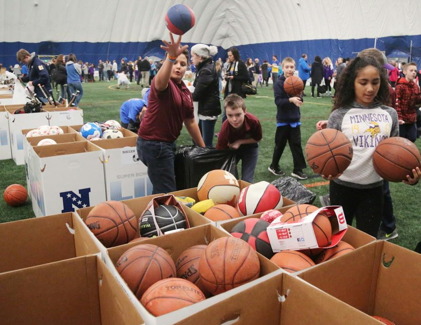 Tens of thousands of books, school supplies, sports equipments in the hands of underserved children in the greater Twin Cites area thanks to efforts of local students and the National Football League through a Super Bowl project called Super Kids-Super Sharing Thursday, Jan. 18, 2018, at the Braimar Field Dome in Edina, MN. Before the event had even ended 43,460 items had been collected by kids from various Minnesota school districts. Here, Max Coles, a 5th grader at Shakopee Area Catholic Schoo