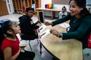 Teacher Marielle Talatala helped Arelis Sigcha Tituana, 9, and Aunyae Devine, 11, with some exercises at Hmong International Academy in Minneapolis on