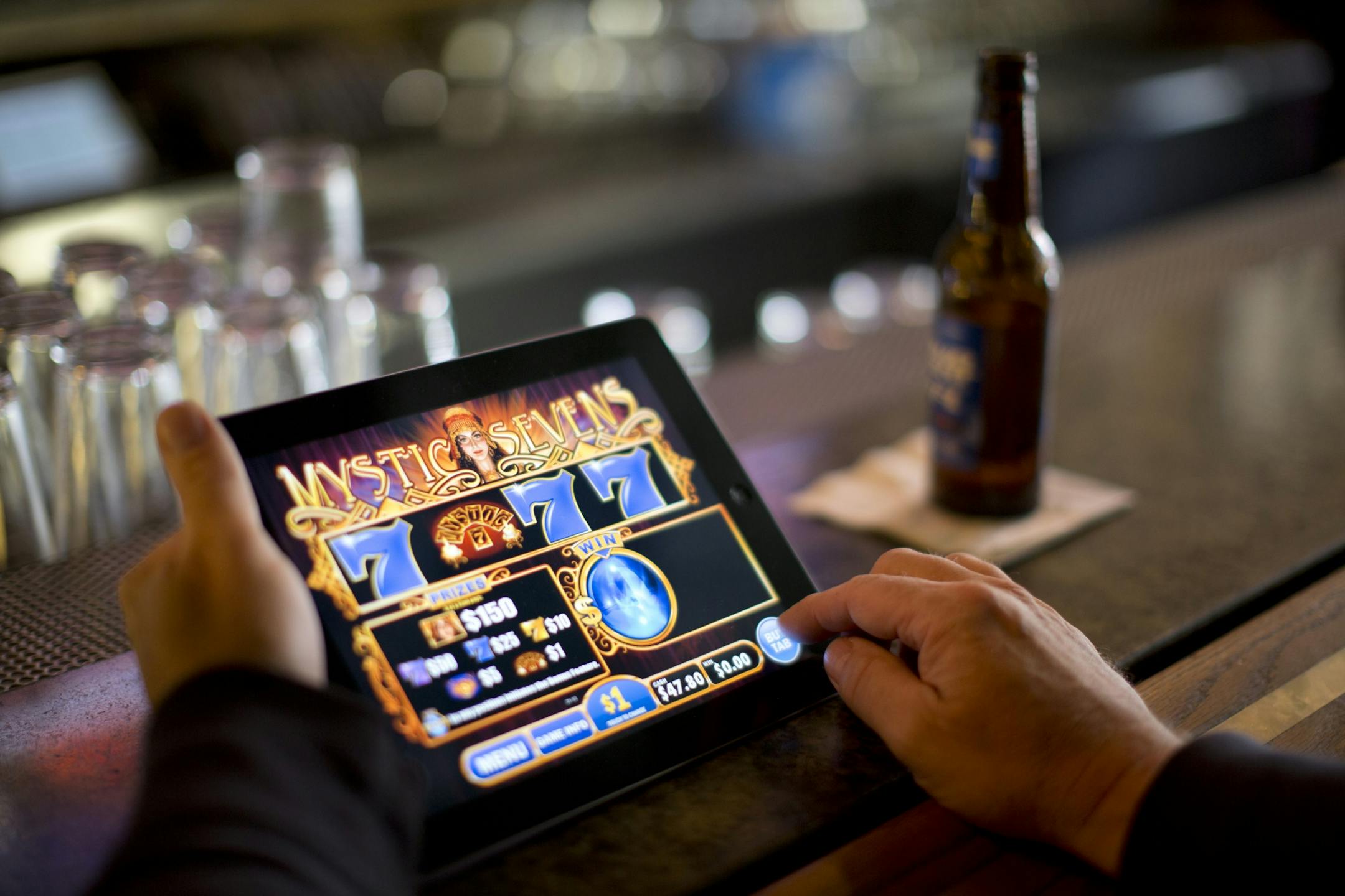 Electronic pulltab devices made their debut in Minnesota Tuesday, September 18, 2012 after receiving state approval. O'Gara's Bar and Grill in St. Paul, MInn. was among a handful of establishments that were operational Tuesday afternoon. Dick Kari played the new electronic pulltab game on an iPad at the bar at O'Gara's Tuesday afternoon. He owns a bar in Proctor, Minn. "I'll be getting one of these next week. These things are neat, I'll tell you!" he said.