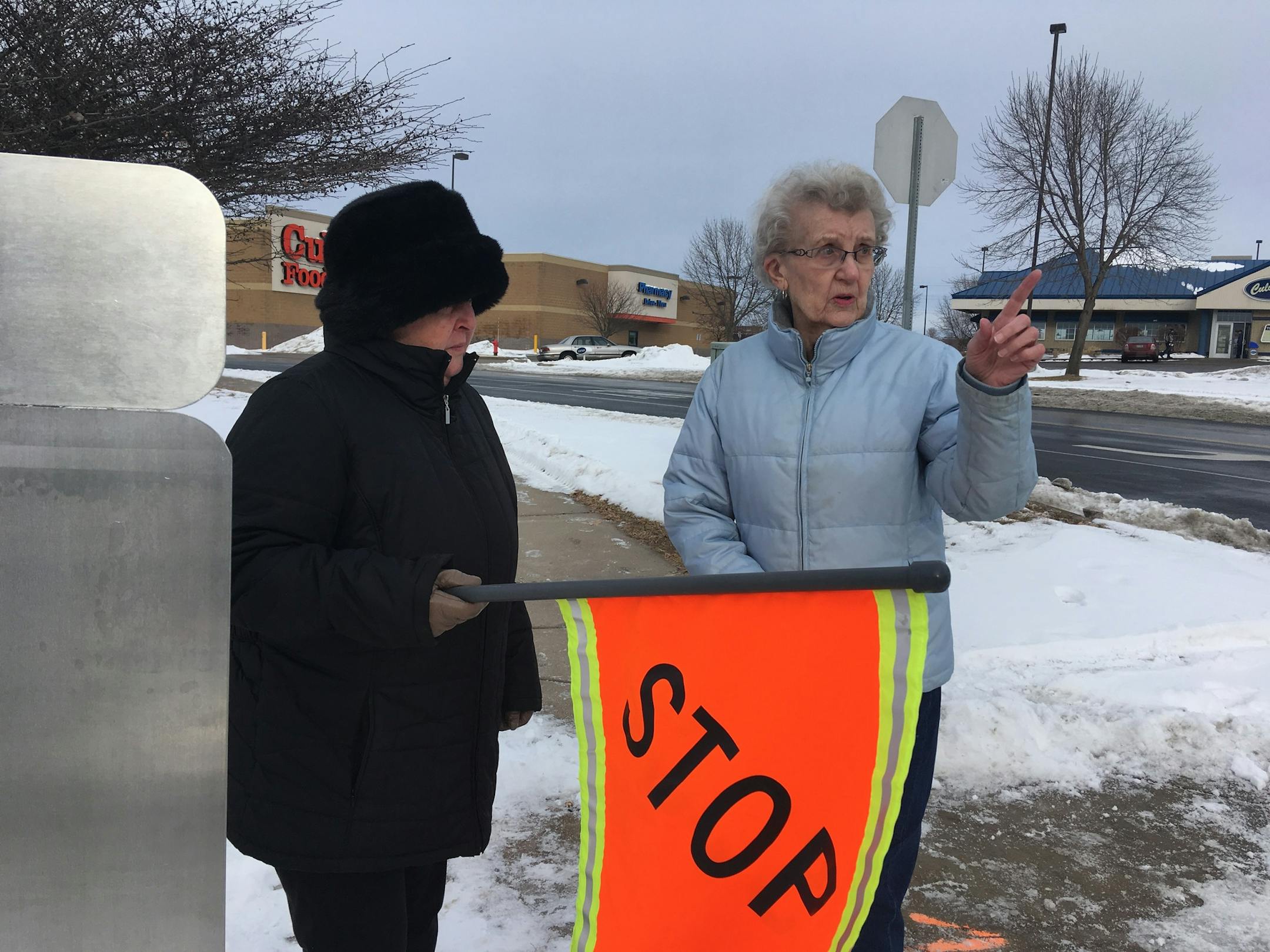 Marjorie Kleven and friend Carol Schlomka try out the new pedestrian flags in Hastings.