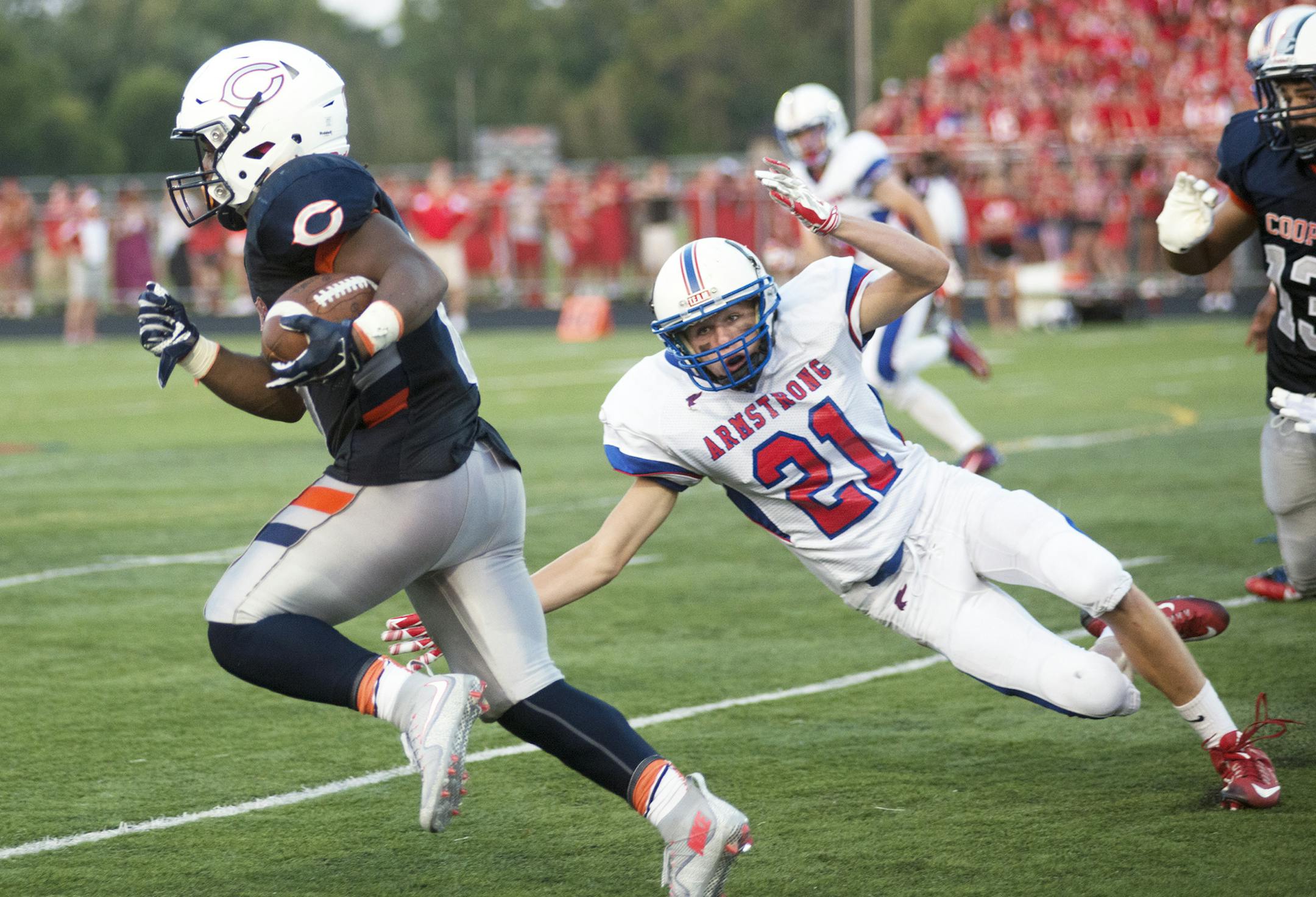 Cooper's Levonte Taylor runs out of reach of Armstrong's Cole Christenson during the first quarter of a game against Armstrong Friday, Sept. 3, at Cooper High School. ] (Matthew Hintz, 0903015, New Hope)