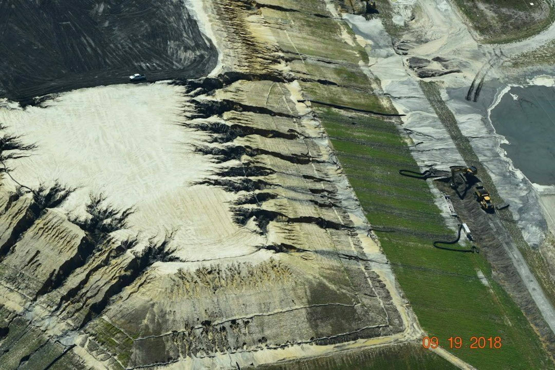 In this Sept. 19, 2018, photo released by Cape Fear River Watch, heavy rains from Hurricane Florence erode and breach a coal ash landfill at the L.V. Sutton Power Station in Wilmington, N.C. The landfill under construction at the site ruptured over the weekend, spilling enough material to fill 180 dump trucks. Coal ash contains arsenic, mercury and other toxic metals.