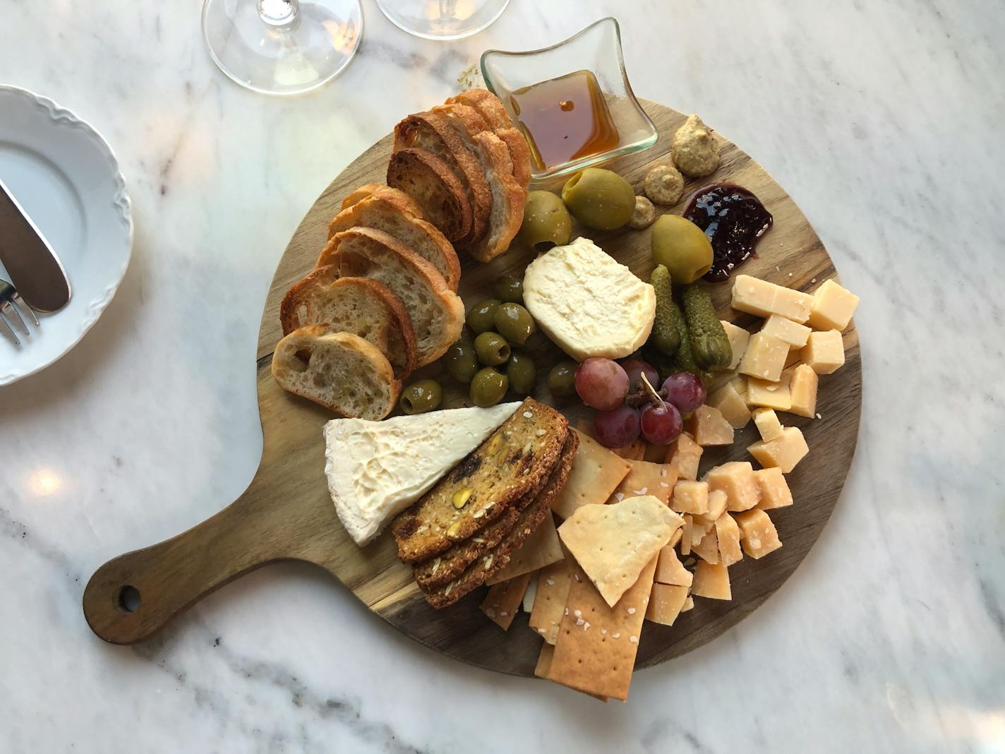 A board with an array of cheese, cracker and bread that is curated by the sommelier at Milly's Wine Bar & Bistro.