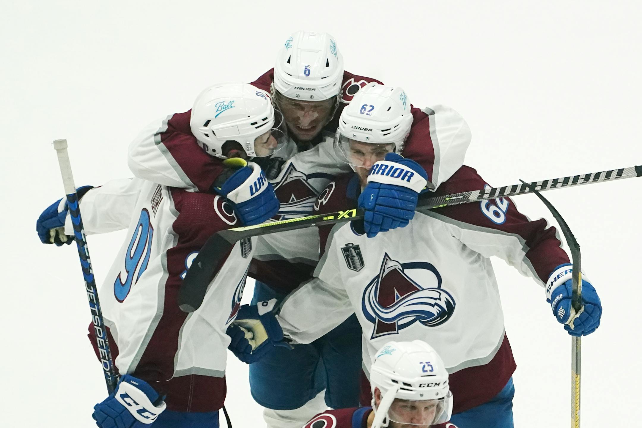 Colorado Avalanche defenseman Erik Johnson, center, and left wing Artturi Lehkonen, right, congratulate center Nazem Kadri, left, after his overtime goal in Game 4