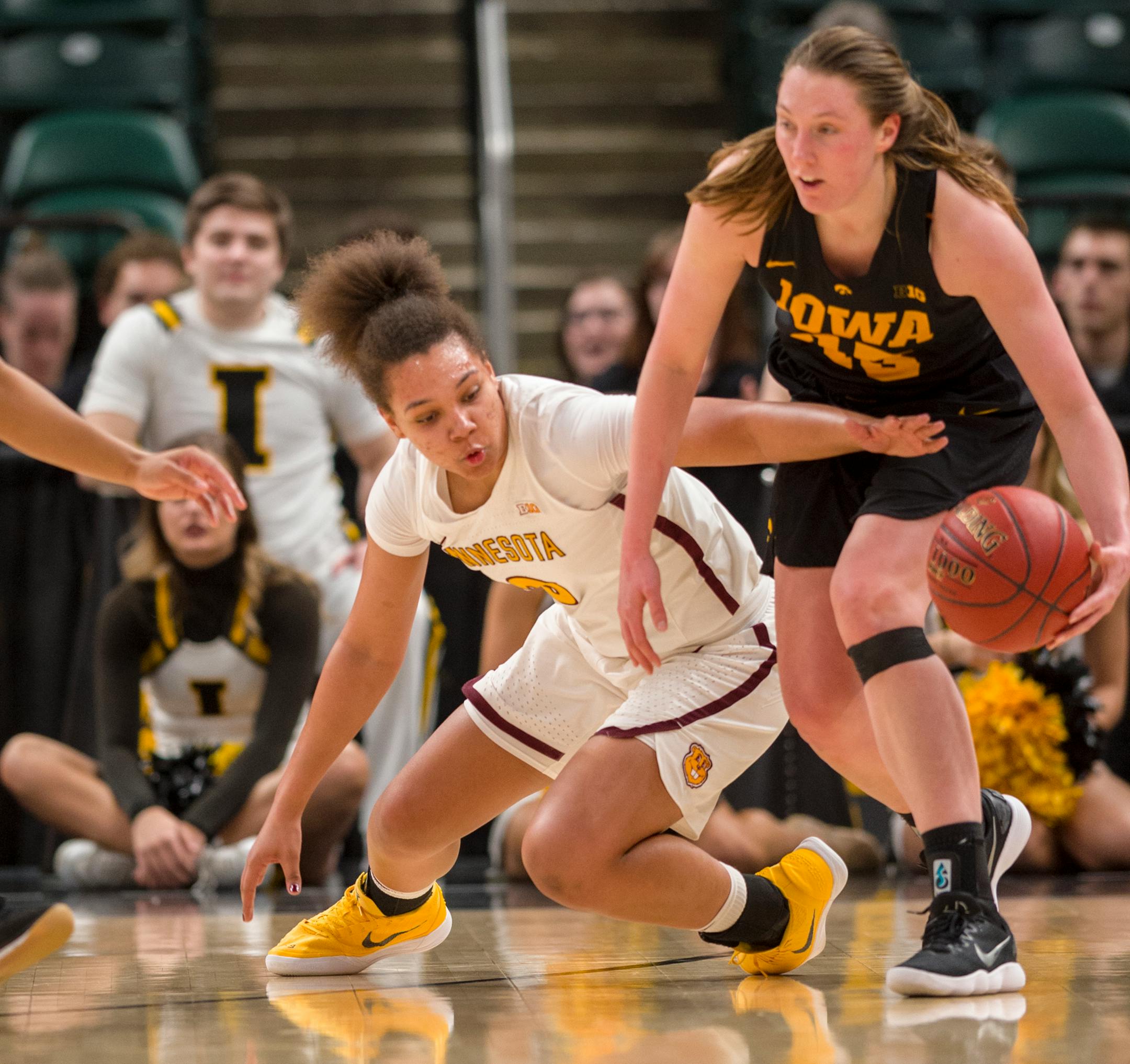 Gophers guard/forward Destiny Pitts battles for the ball with Iowa forward Amanda Ollinger during the second half in the 2018 Big Ten Women's Basketball Tournament