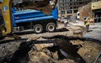 A sinkhole caused by a water main break developed in front of Kelly's Pub in downtown St. Paul. St. Paul Regional Water Services was hard at work prep