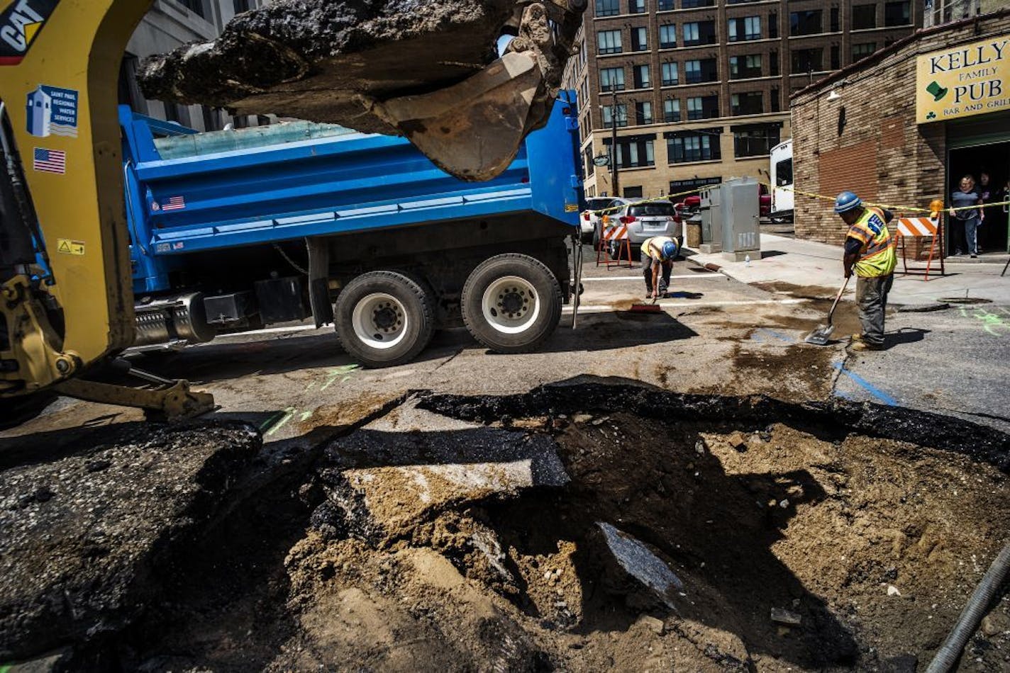 A sinkhole caused by a water main break developed in front of Kelly's Pub in downtown St. Paul. St. Paul Regional Water Services was hard at work prepping the site for repairs.