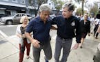 Wilmington Mayor Bill Saffo, left, and North Carolina Gov. Roy Cooper walk down Market St. during a tour of downtown Wilmington, N.C., Friday, Sept. 2