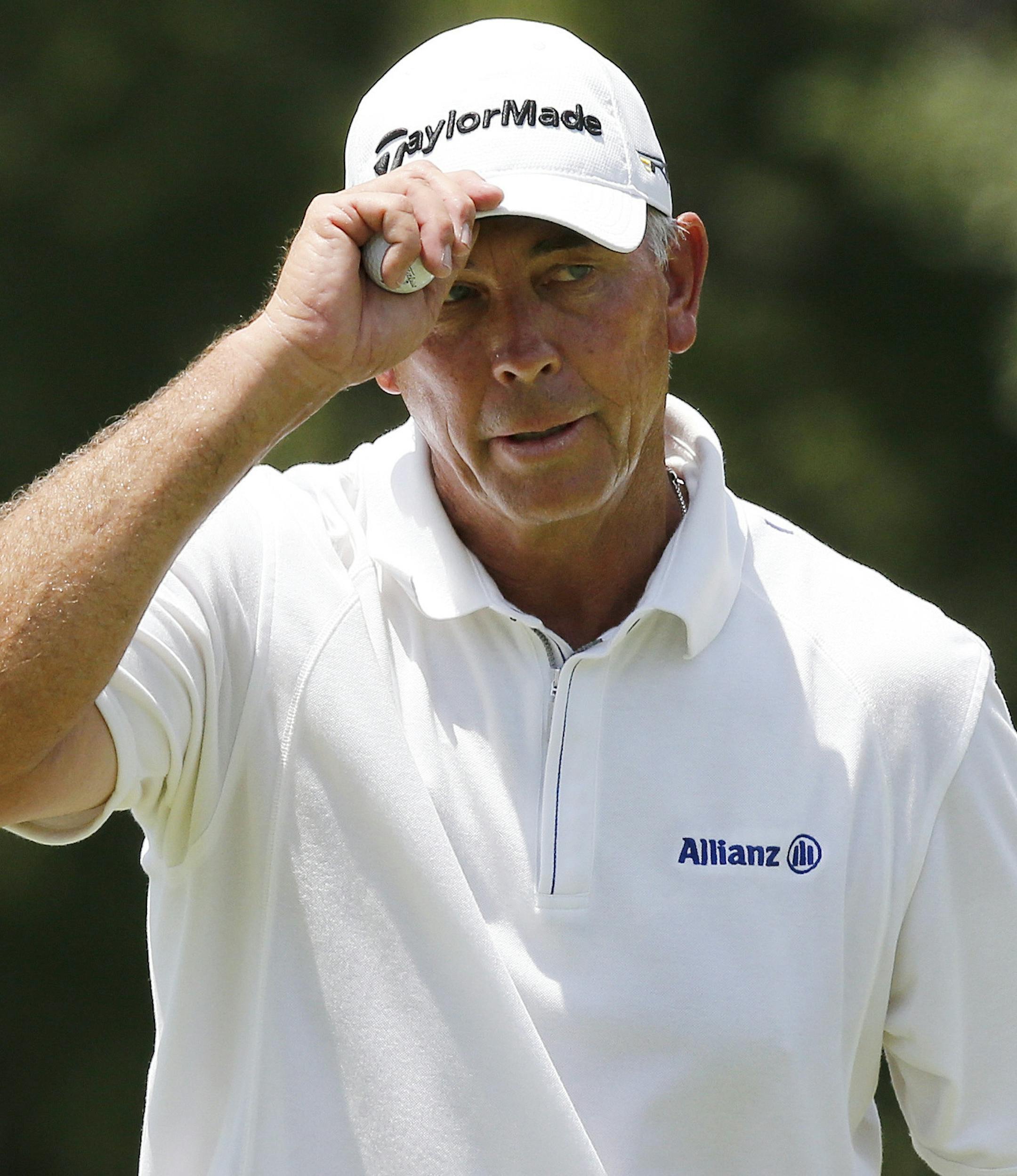Tom Lehman tips his hat on the ninth green in the first round of play at the 2014 U.S. Senior Open golf tournament at Oak Tree National in Edmond, Okla., Thursday, July 10, 2014. (AP Photo/Sue Ogrocki) ORG XMIT: OKSO