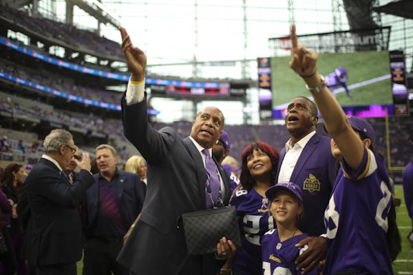 Kevin Warren pointed out something in the stands while standing on the sidelines with Ahmad Rashad and his family before last month's game against Det