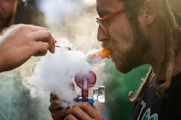 Derrick Strauss, a cannabis glassware artist, on Tuesday enjoyed a puff on a dab rig in Minneapolis. 