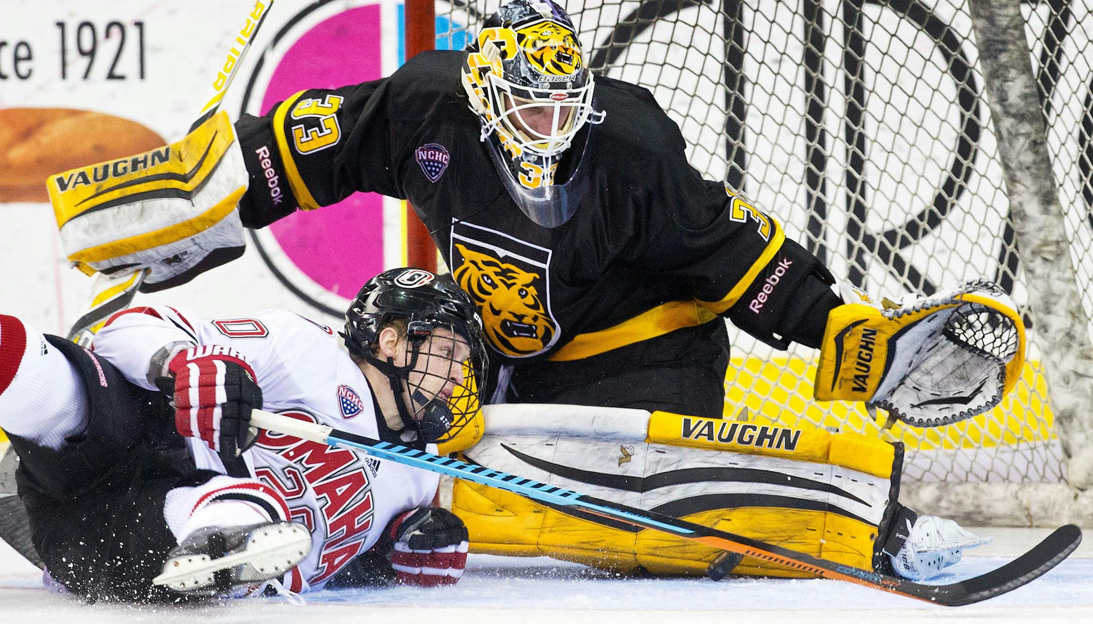 Nebraska-Omaha's Jake Guentzel slides into Colorado College goalie Tyler Marble during the third period of a hockey game Saturday, March 7, 2015, in Omaha, Neb. (AP Photo/Omaha World-Herald, Chris Machian)