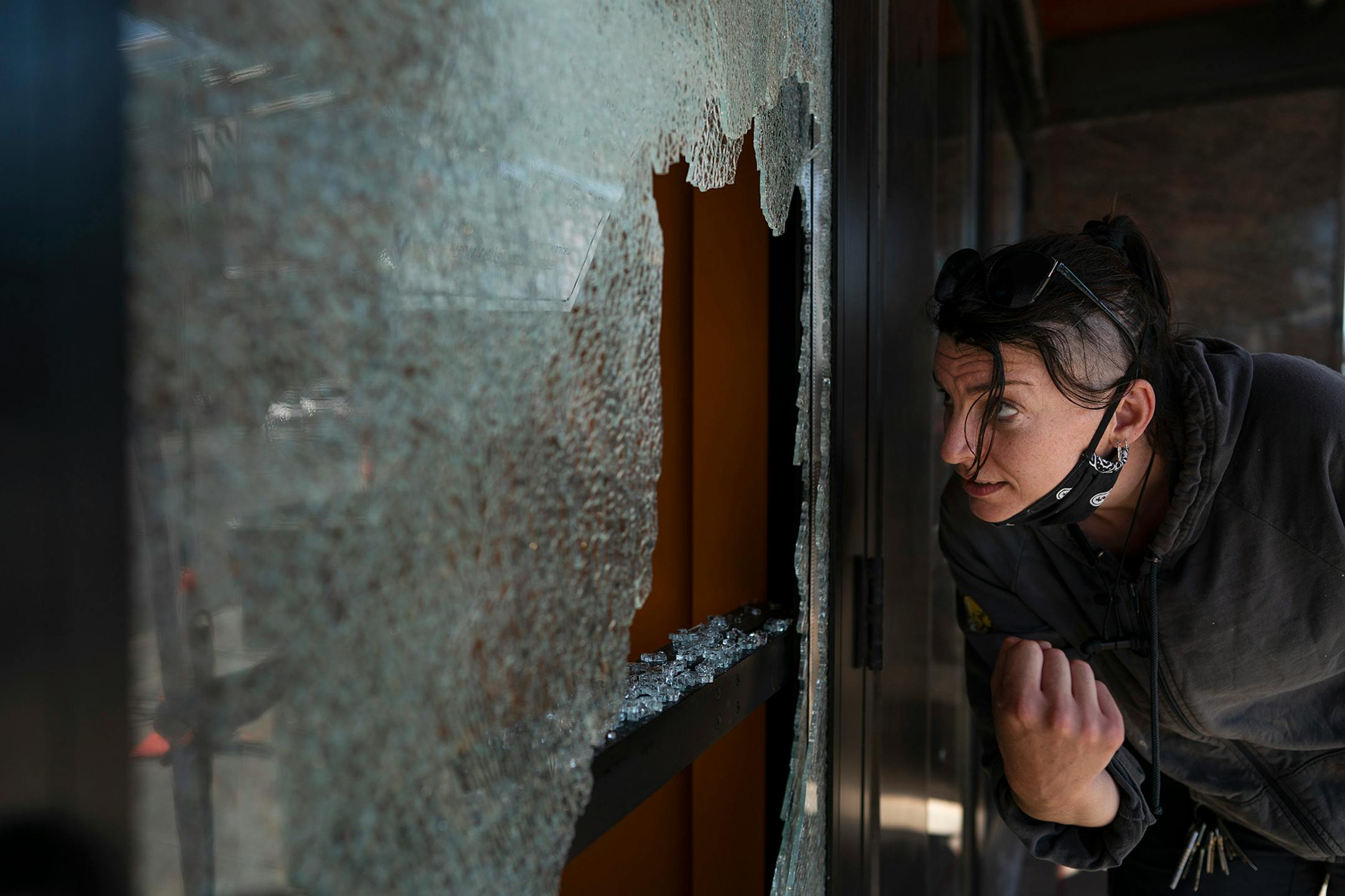 Megan Culverhouse, an employee at John Fluevog shoe store, cleaned up broken glass.