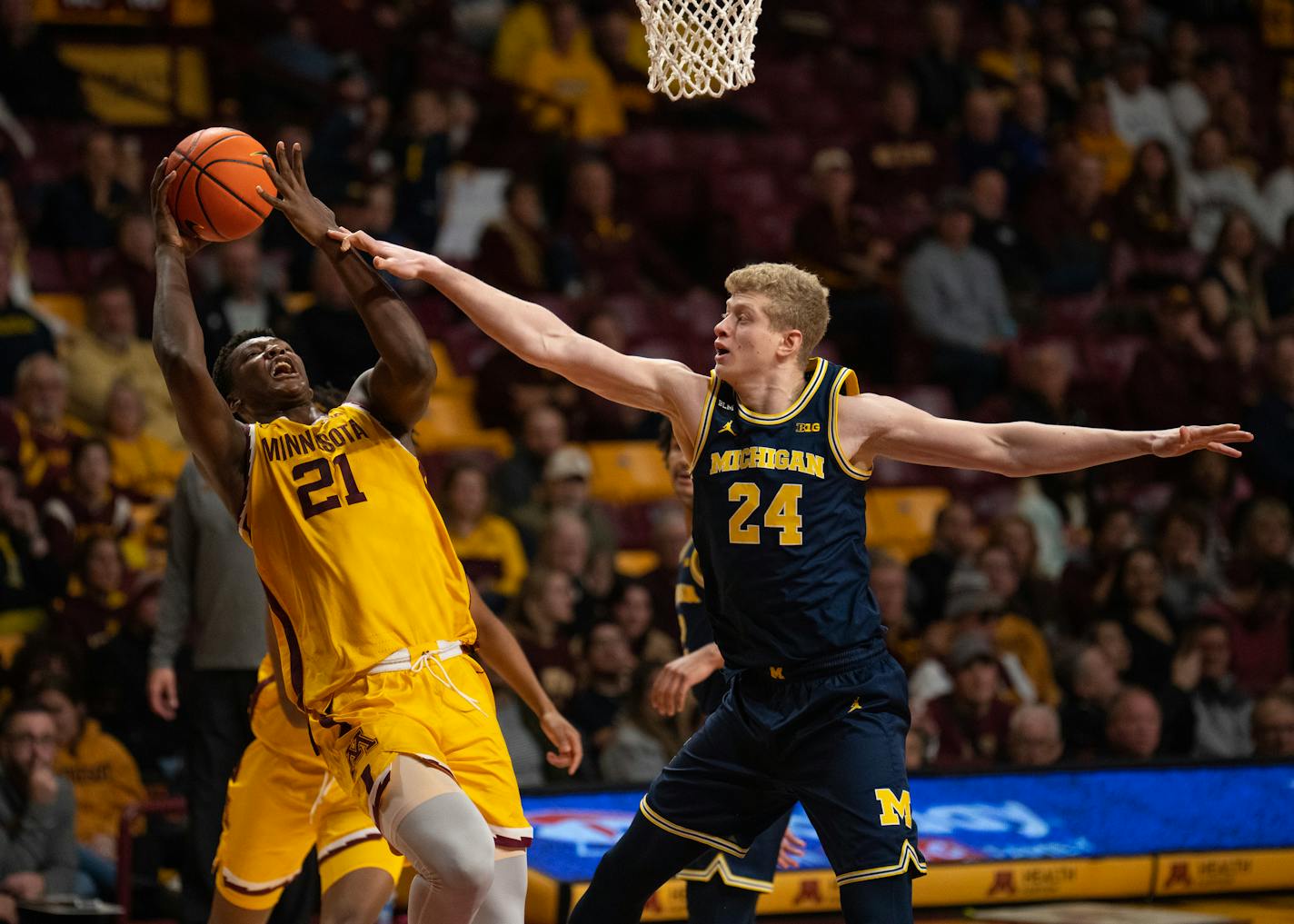 Minnesota Gophers forward Pharrel Payne (21) tried to get a shot off as he was fouled by Michigan Wolverines forward Youssef Khayat (24) during the second half Thursday night, December 8, 2022 at Williams Arena in Minneapolis. The University of Minnesota Gophers lost to the Michigan Wolverines 90-75 in a Big Ten Conference basketball game. ] JEFF WHEELER • jeff.wheeler@startribune.com