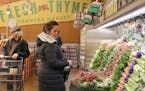Deb Rasinski chooses vegetables on Tuesday, April 10, 2018 at the Fresh Thyme Market opening in Minneapolis, Minn. Rasinksi said the market is a new c