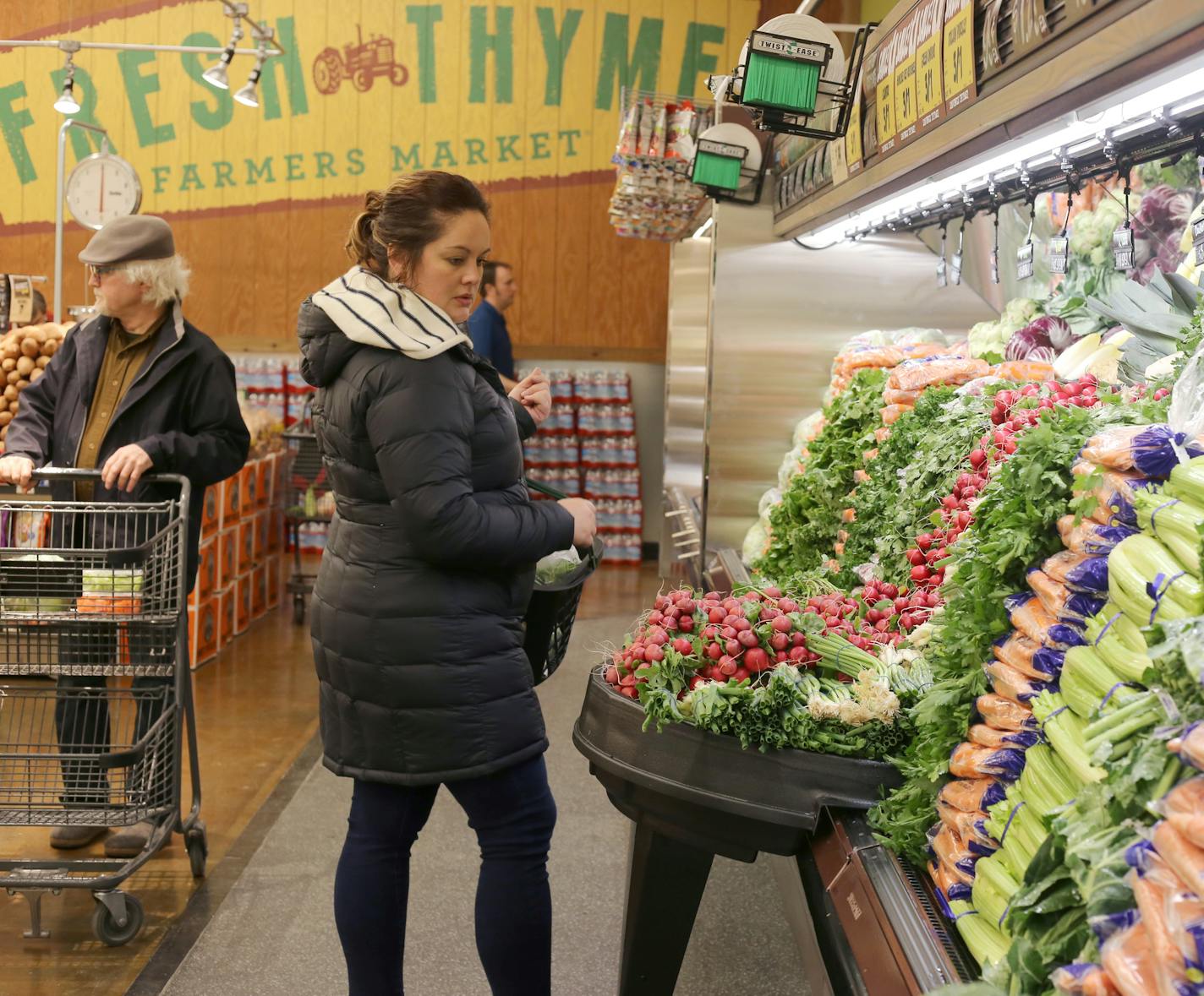 Deb Rasinski chooses vegetables on Tuesday, April 10, 2018 at the Fresh Thyme Market opening in Minneapolis, Minn. Rasinksi said the market is a new convenience since she works across the street. [Ellen Schmidt &#xef; ellen.schmidt@startribune.com