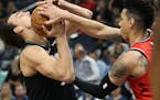 Wolves forward Dario Saric fought for possession of the ball against the Raptors' Danny Green in the first half Tuesday.