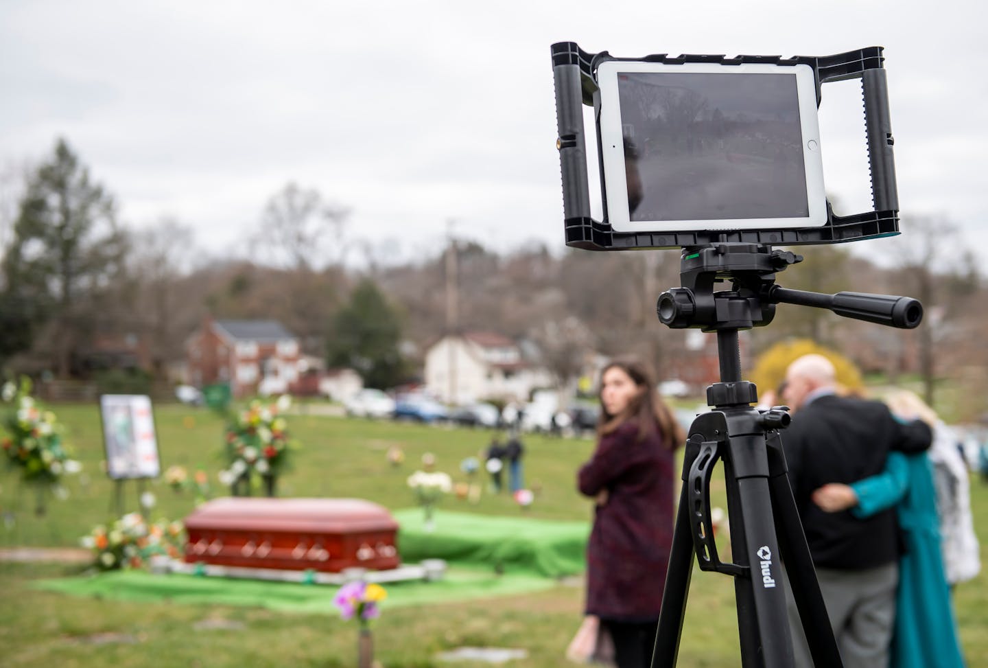 Guests mourn during a live-streamed funeral in March. The pandemic has made in-person funerals difficult to hold and many families are struggling with grieving relatives amid social distancing requirements and travel restrictions.