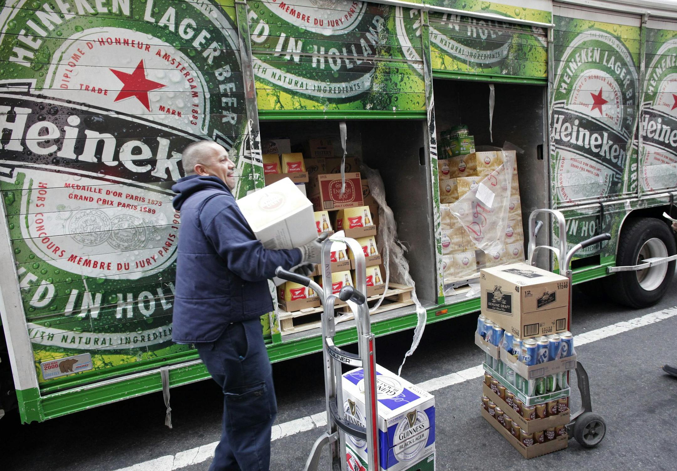 FILE - In this March 28, 2012 file photo, a truck driver delivers Heineken beer and other drinks in New York. Heineken, a Dutch brewing company based in Amsterdam, said Friday, July 20, it is offering $4.1 billion to buy out its partner in the Singapore-based maker of Tiger beer, attempting to neutralize a Thai tycoon's competing bid for influence over the brand as the Dutch brewer expands in emerging markets. (AP Photo/Mark Lennihan, File)