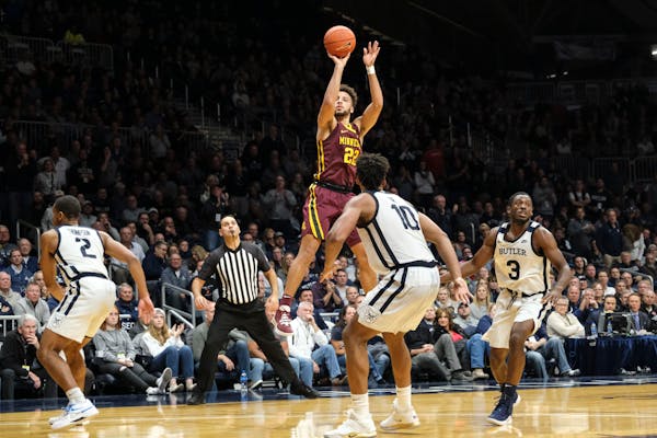 Gophers guard Gabe Kalscheur shoots in front of Butler forward Bryce Nze during a game earlier this month.