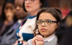 Thalia Williams, 11, listens as the presenter announces her name for the outstanding citizen award during the Hennepin County Attorney's Office Commun