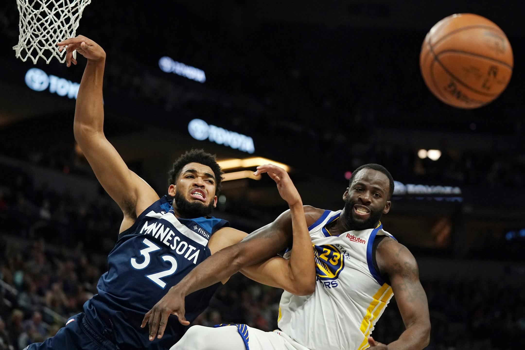 Minnesota Timberwolves center Karl-Anthony Towns (32) and Golden State Warriors forward Draymond Green (23) went up for a rebound in overtime.