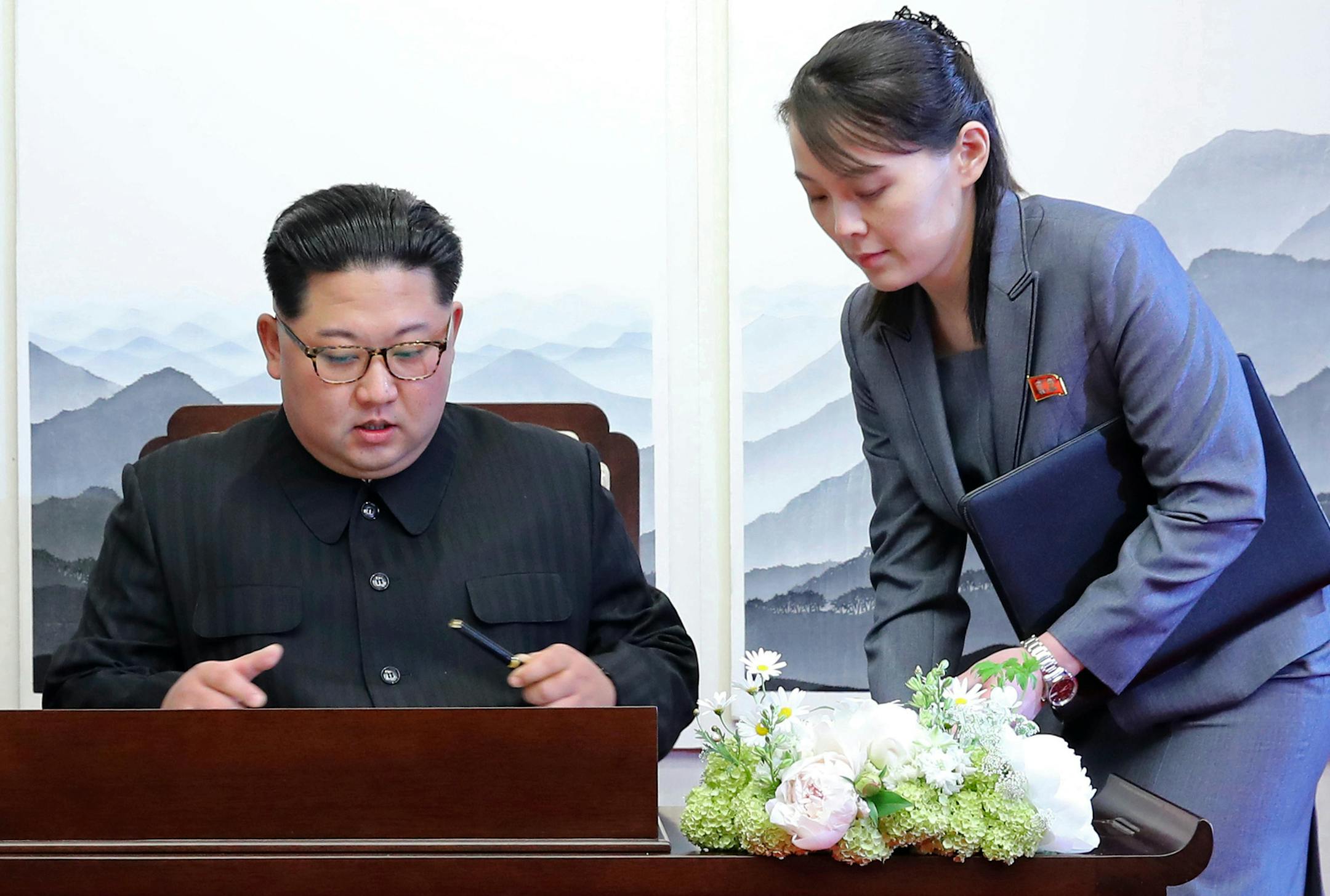 FILE - In this Friday, April 27, 2018, file photo, North Korean leader Kim Jong Un signs a guestbook next to his sister Kim Yo Jong, right, inside the Peace House at the border village of Panmunjom in Demilitarized Zone. Kim’s younger sister handed her brother a pen when he signed the guestbook. Her proximity to her brother during most of the summit events Friday added credence to speculation that she’s virtually the No.2 in the North. (Korea Summit Press Pool via AP, File)