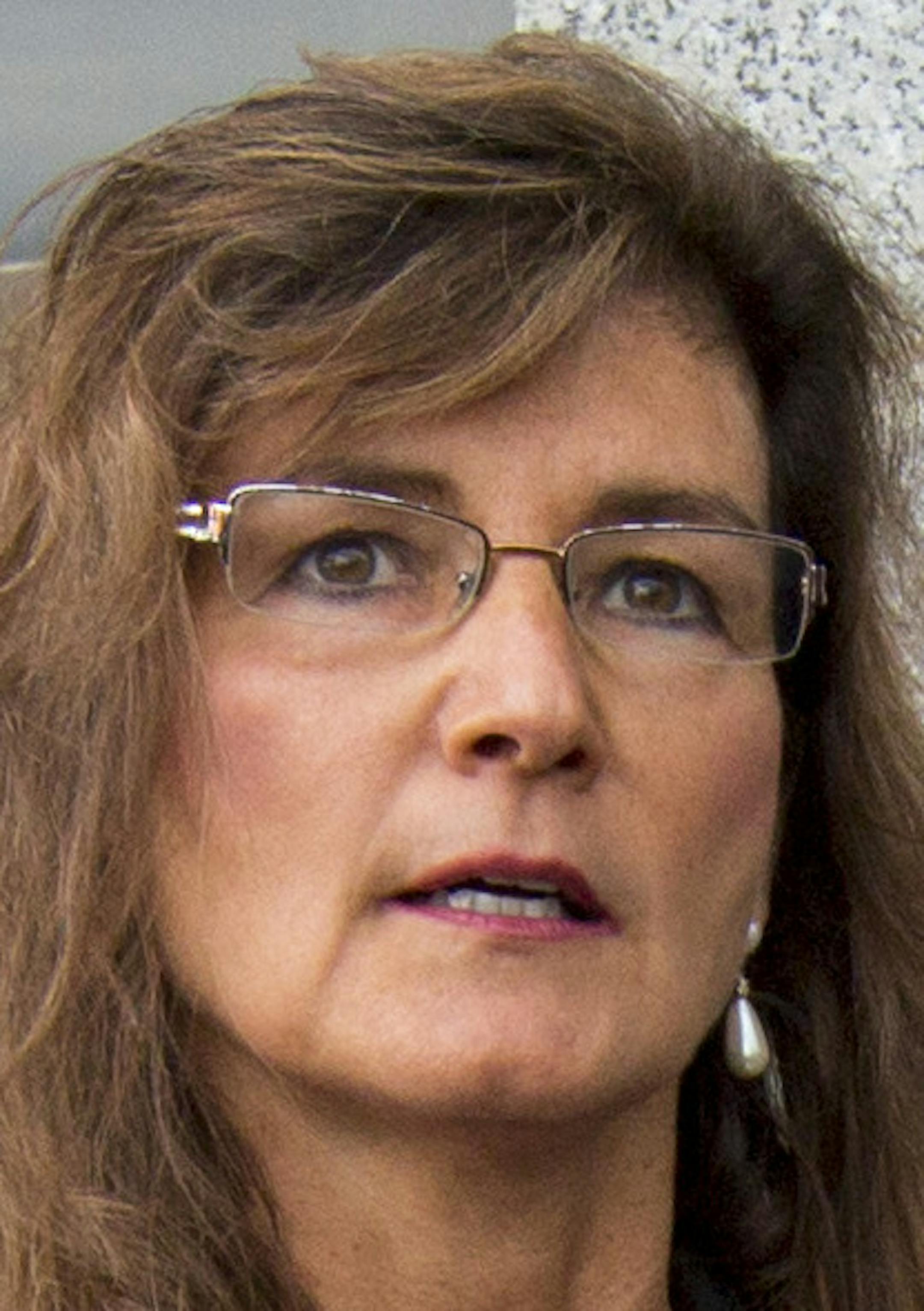 Michelle MacDonald, the Republican Party's endorsed candidate for Minnesota Supreme Court (center), announced a complaint filed against the party, Chairman Keith Downey and others, alleging they attempted to coerce her into giving up her endorsement. ] BRIAN PETERSON ‚Ä¢ brian.peterson@startribune.com St. Paul, MN 09/03/14