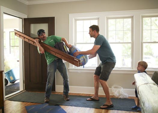 Justin Dering, right, helped mover Al Nelson of Matt’s Moving as the Derings moved into their new Minneapolis house in June.