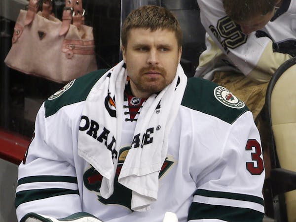 Minnesota Wild goalie Ilya Bryzgalov watches from the bench in the first period of a NHL pre-season hockey game against the Pittsburgh Penguins in Pit