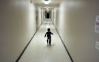 FILE - In this Dec. 11, 2018, file photo, an asylum-seeking boy from Central America runs down a hallway after arriving from an immigration detention 