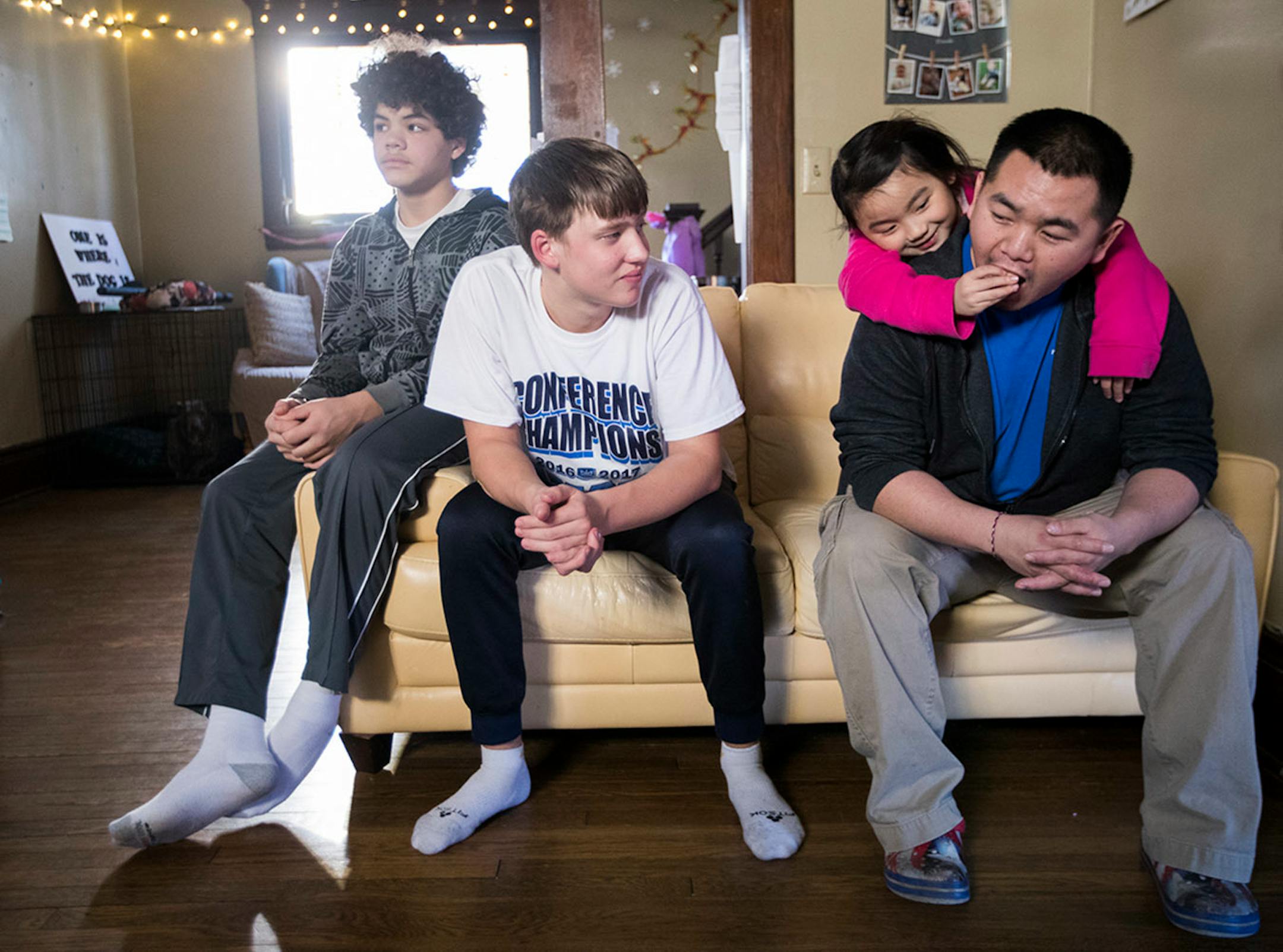 Minnehaha Academy students Daniel Rose, from left, 14, and Peter Shaffer, 14, hang out with Ken Vue and his daughter Diav Vue, 7, while staying at their home in St. Paul. ] LEILA NAVIDI ï leila.navidi@startribune.com BACKGROUND INFORMATION: in St Paul on Wednesday, March 15, 2017. City Stay is an opportunity for Minnesota high school students to do home stays at the homes of other local residents. The cultural exchange program fosters new relationships among Minnesota's European, Latin American,