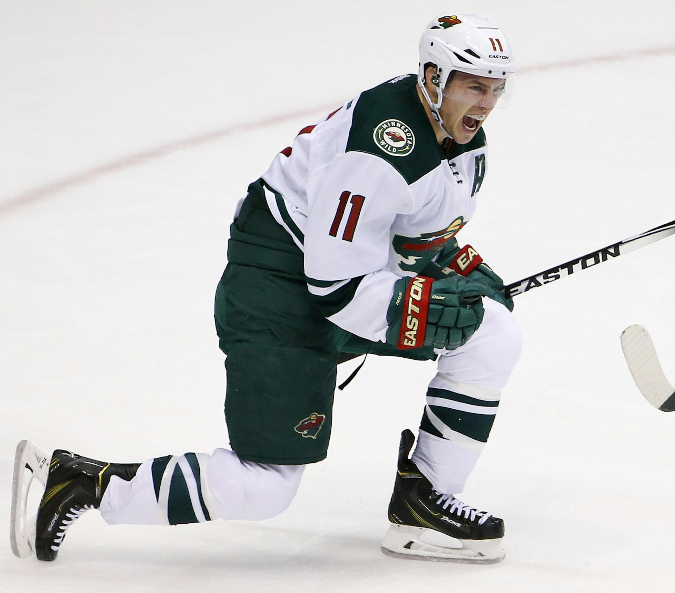 Minnesota Wild's Zach Parise celebrates his game-tying goal against the Arizona Coyotes during the third period of an NHL hockey game Saturday, Dec. 13, 2014, in Glendale, Ariz. The Wild defeated the Coyotes 4-3 in a shootout. (AP Photo/Ross D. Franklin) ORG XMIT: PNJ115