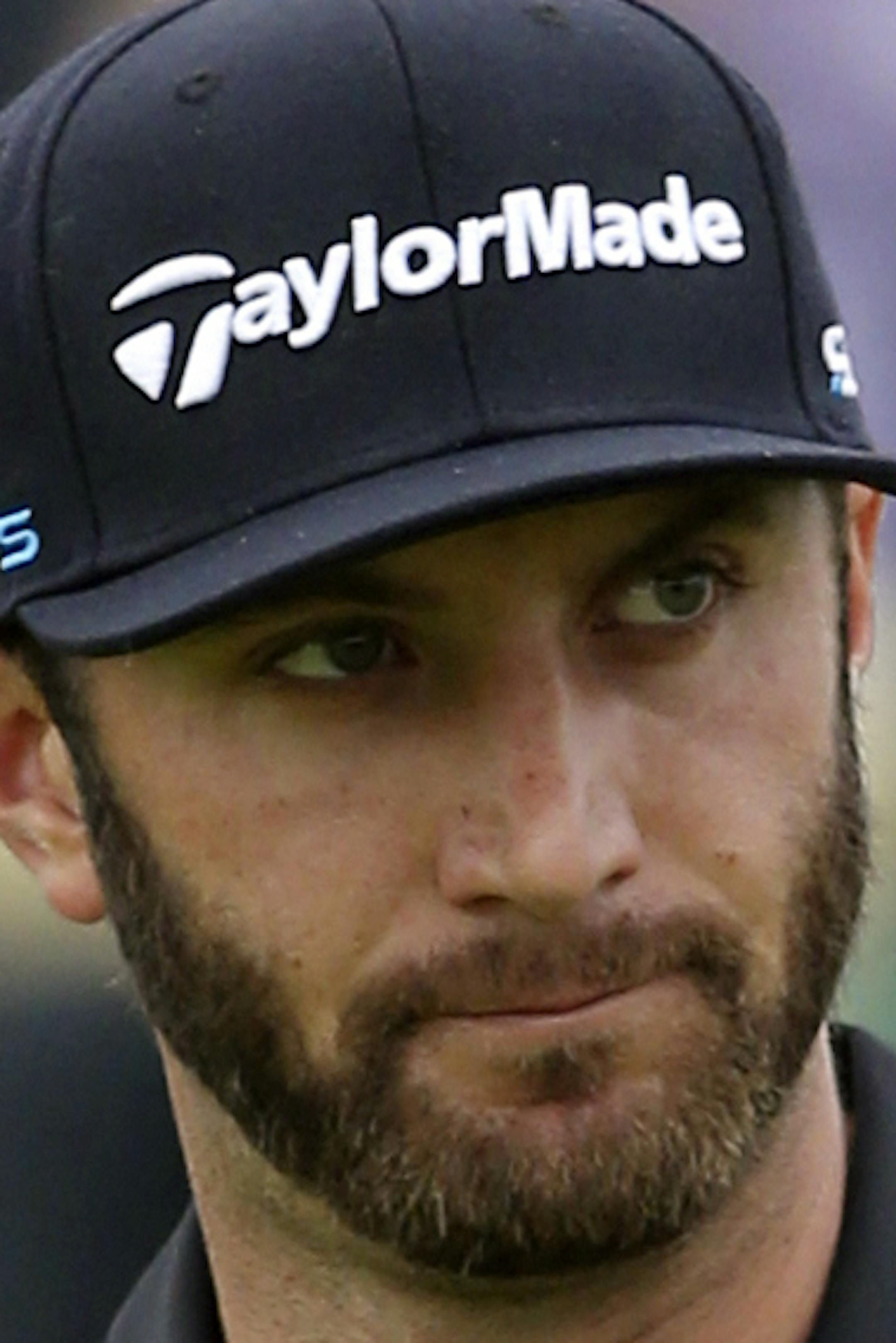 FILE - In this July 19, 2014, file photo,Dustin Johnson acknowledges the gallery after holing his putt on the first green during the third day of the British Open Golf championship at the Royal Liverpool golf club, Hoylake, England. Johnson says in a magazine interview that cocaine is not the reason he chose to sit out the last six months to get his life in order. Johnson said in August that he was taking a leave of absence from the PGA Tour to seek professional help for what he called "personal