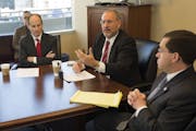 U.S. Attorney Andy Luger, Center, state Commerce Commisioner Mike Rothman (left) and C.J. Kerstetter of the SEC (right) unveil new initiatives to go a