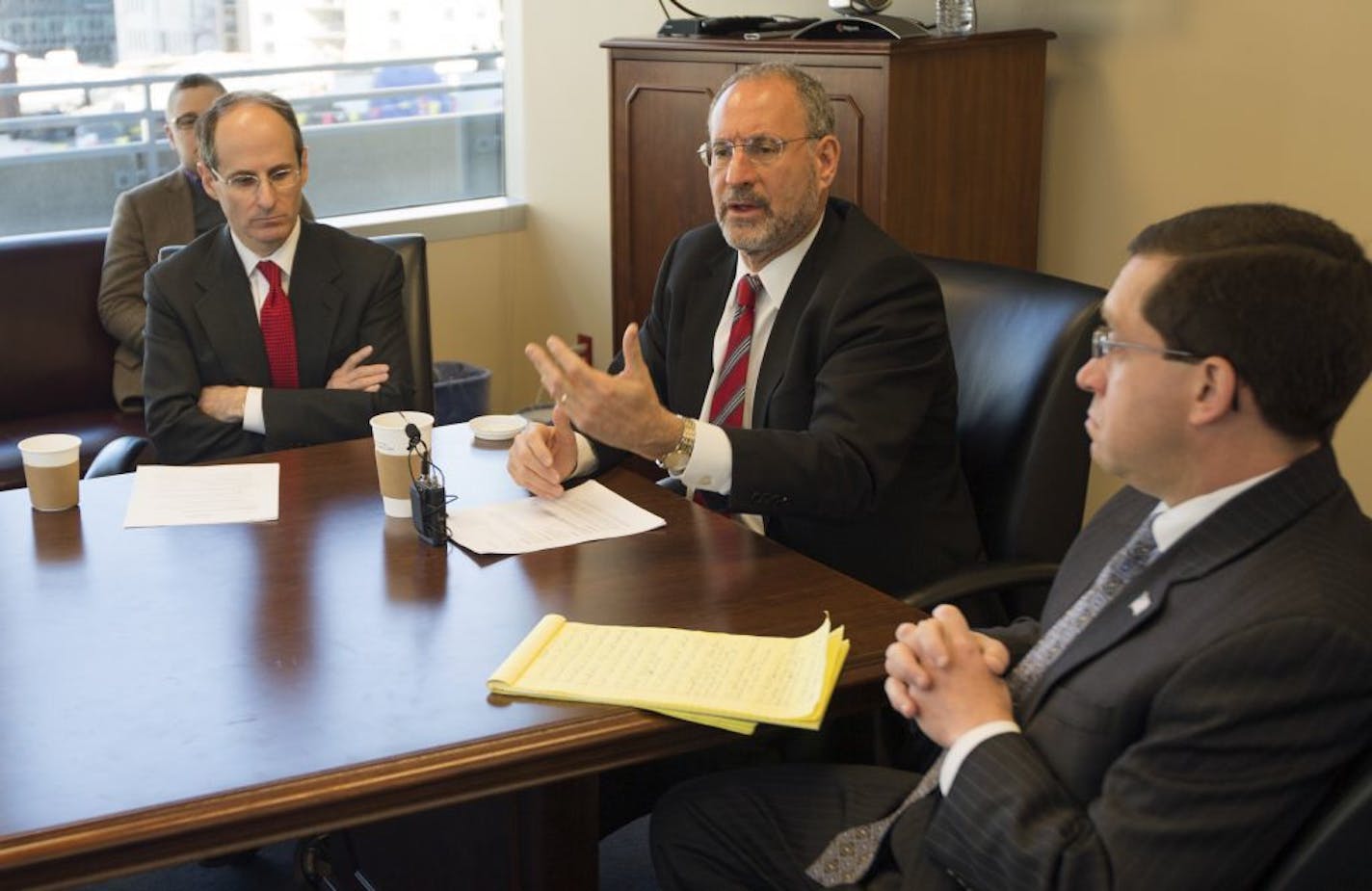 U.S. Attorney Andy Luger, Center, state Commerce Commisioner Mike Rothman (left) and C.J. Kerstetter of the SEC (right) unveil new initiatives to go after investment advisor fraud.